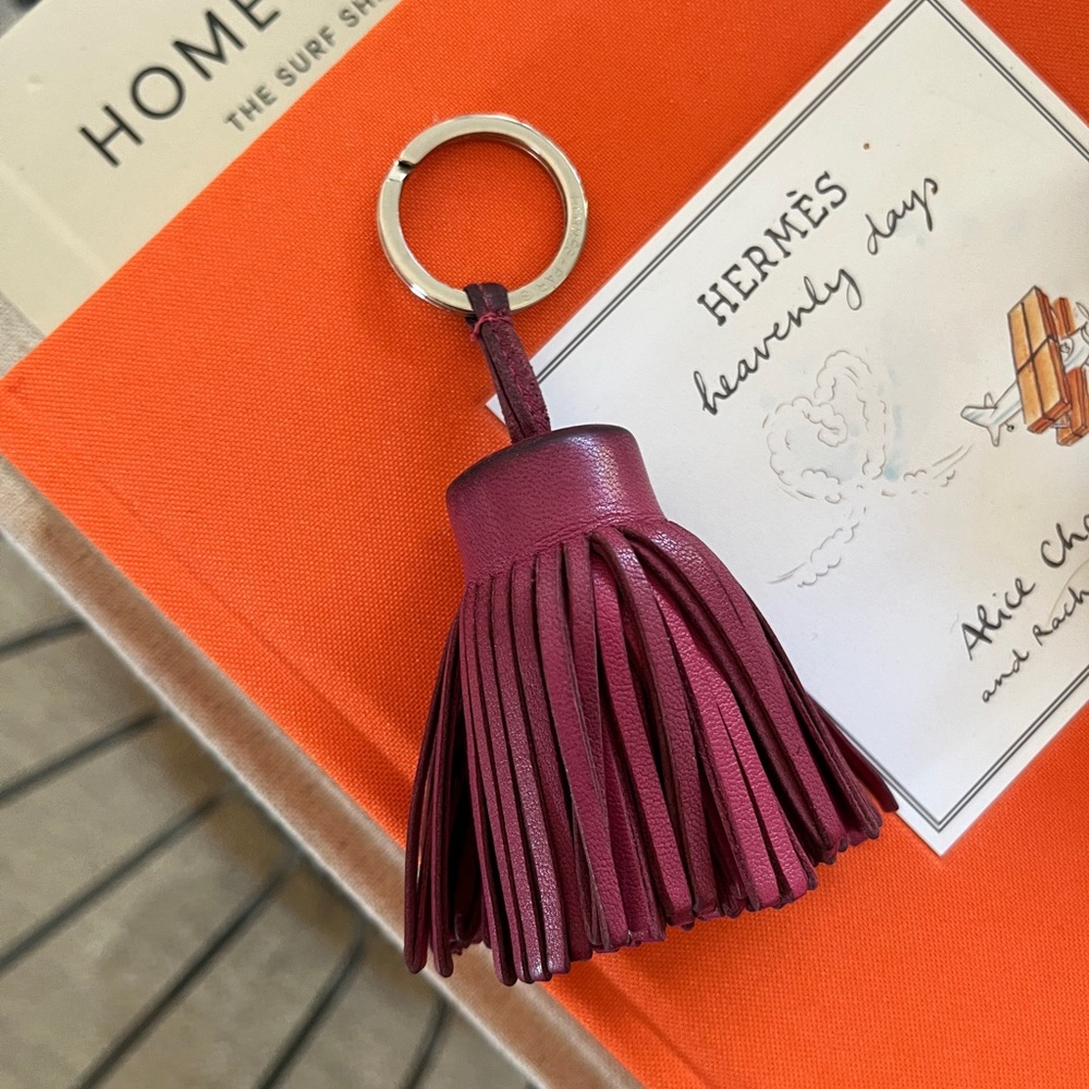 HERMES Carmen Tassle Bag Charm or Key Chain. Light maroon color. 100 % Leather.